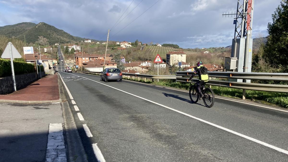 Un ciclista a la entrada del barrio busturitarra de San Cristóbal.