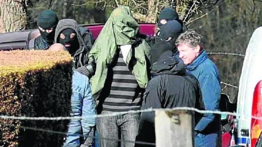 La Policia saca del domicilio de Cahan, en Normandía, a uno de los tres presuntos miembros de ETA detenidos.