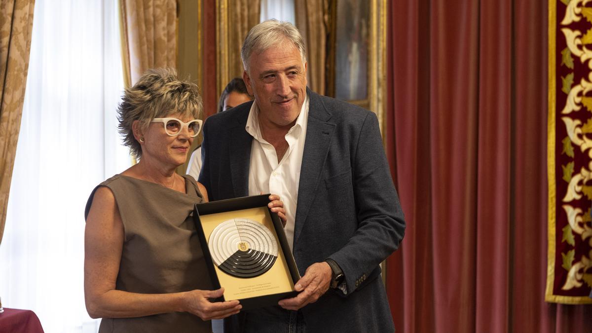 Su viuda, Arantxa Bakaikua, al recibir una escultura basada en la unión de los tres burgos.