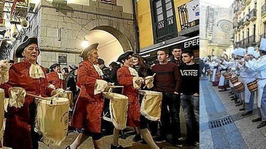 Un grupo de mujeres recorre el centro urbano de Azpeitia durante la pasada tamborrada de la víspera de San Sebastián. A la derecha, una tamborrada interpreta una pieza en el casco histórico donostiarra.