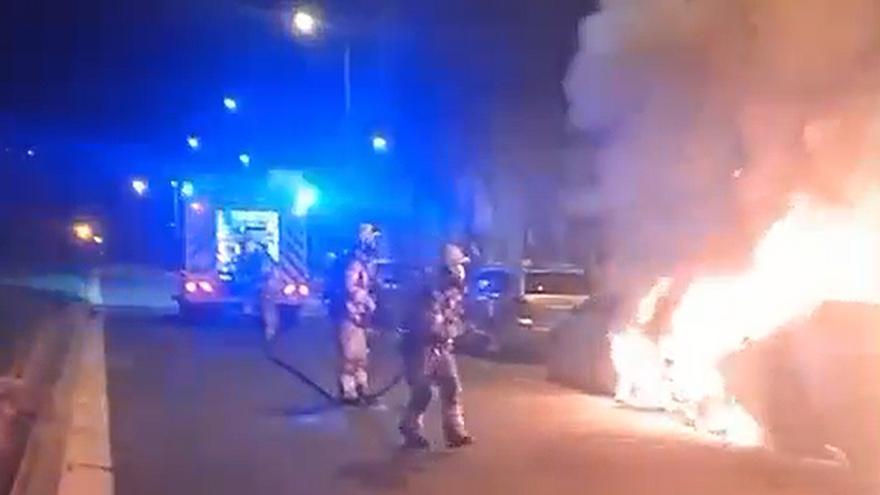 Arden dos coches aparcados en una avenida del barrio de Zabalgana en Vitoria
