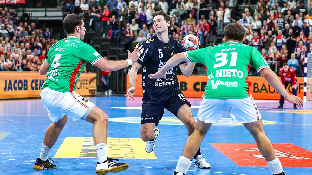 Los jugadores del Irudek Bidasoa Irun Marko Jevtic y Gorka Nieto defienden a Niclas Kirkeløkke en el partido ante Flensburg en el Campushalle