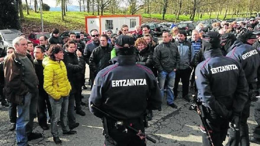 Agentes de la Ertzaintza impiden el paso de los trabajadores a la planta de Unipapel en Aduna.