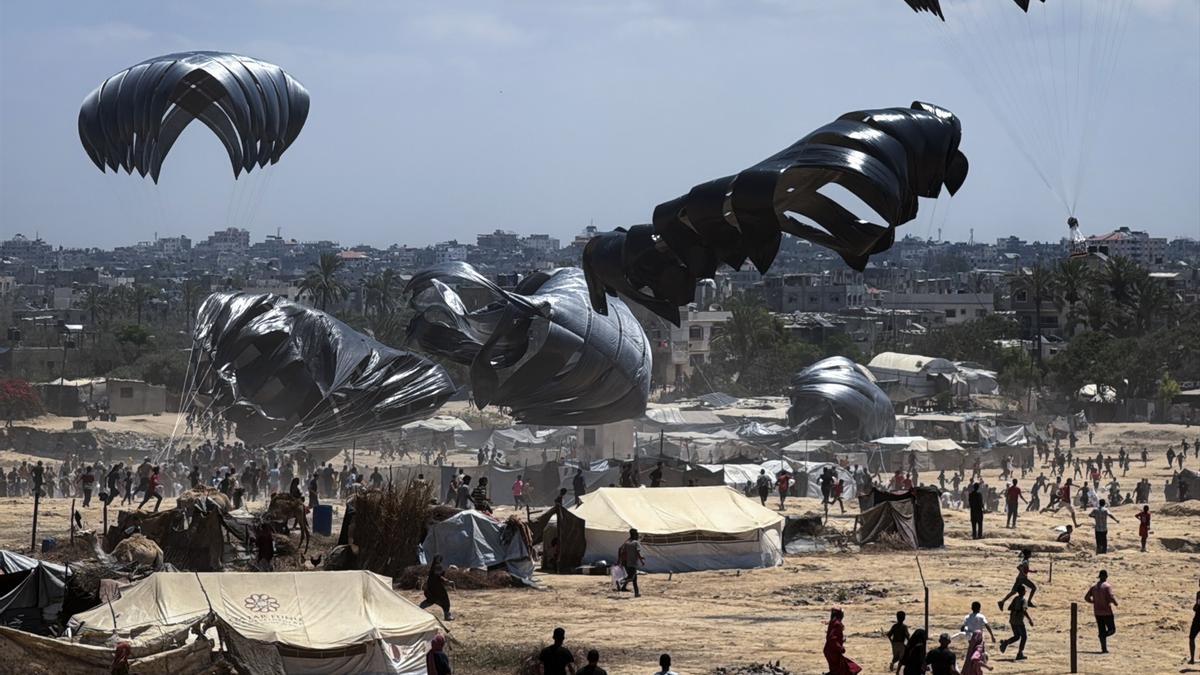 Suministros de ayuda humanitaria cayendo en paracaídas sobre Gaza.
