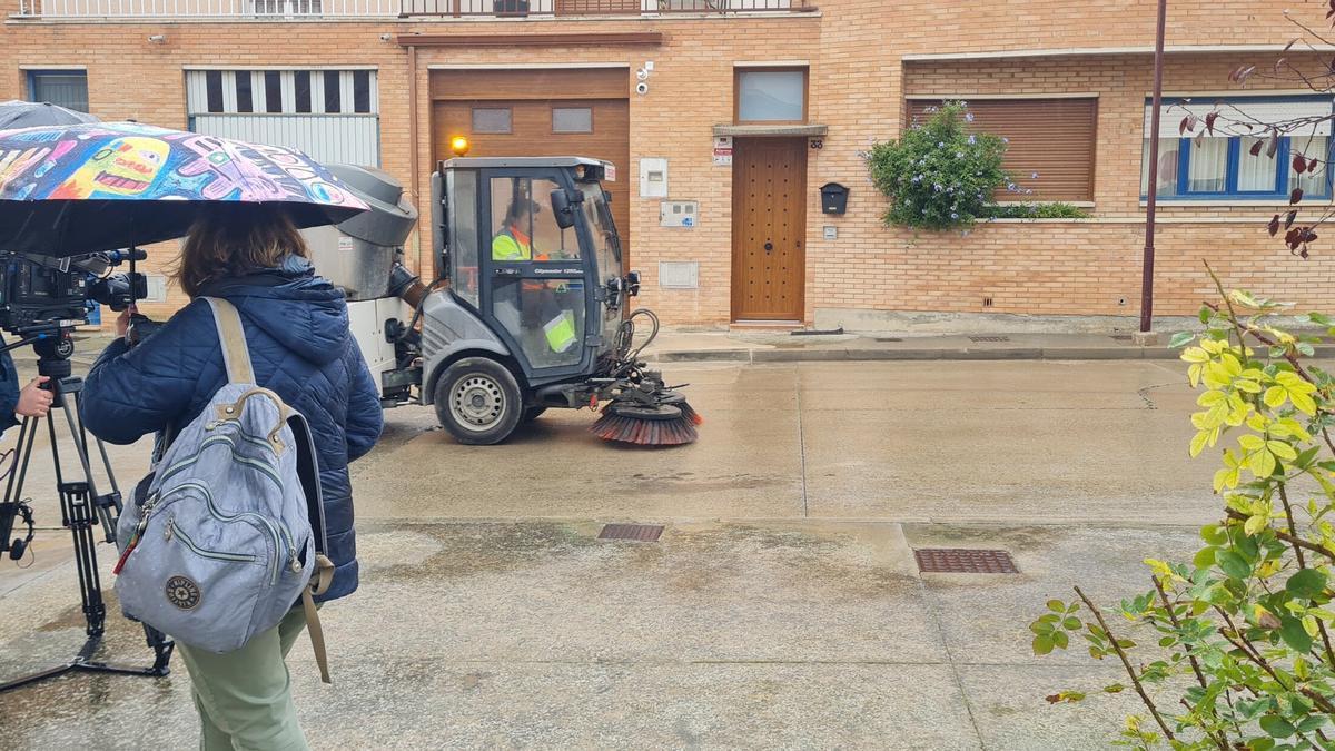 Una barredora pasa ante los periodistas y frete a la casa de Cerdán.