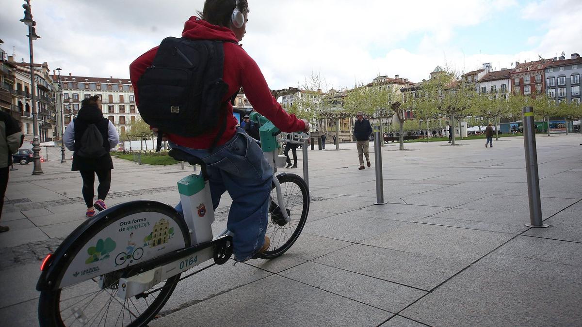 Un hombre circula con una bicicleta eléctrica de alquiler del Ayuntamiento de Pamplona