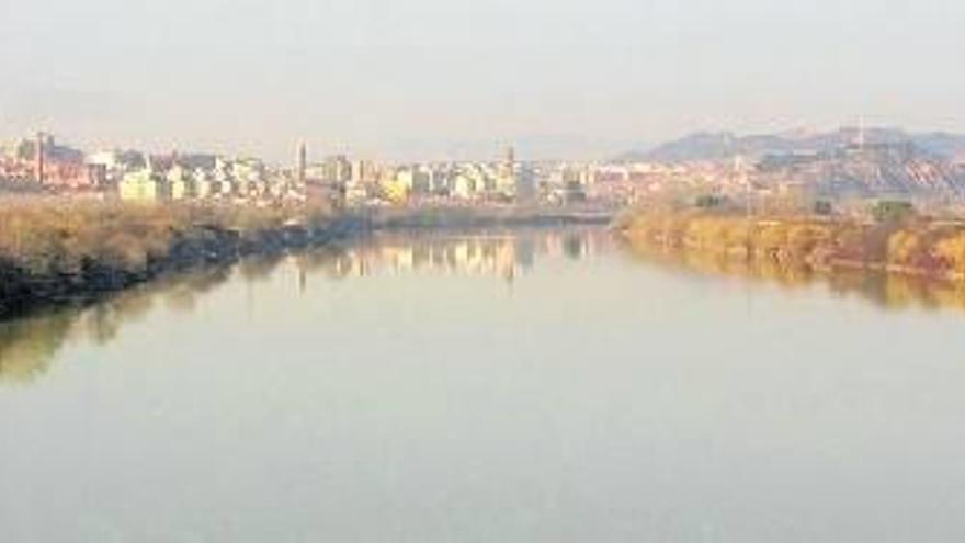 Vista panorámica del Ebro a su paso por Tudela con el paseo del Prado en primer término y al fondo el puente, la catedral y el Corazón de Jesús.