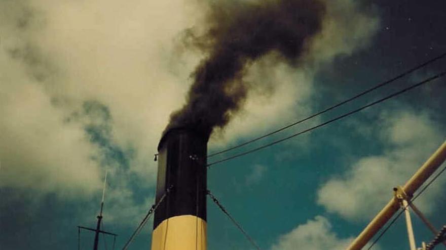 Una chimenea de una fábrica echando humo.