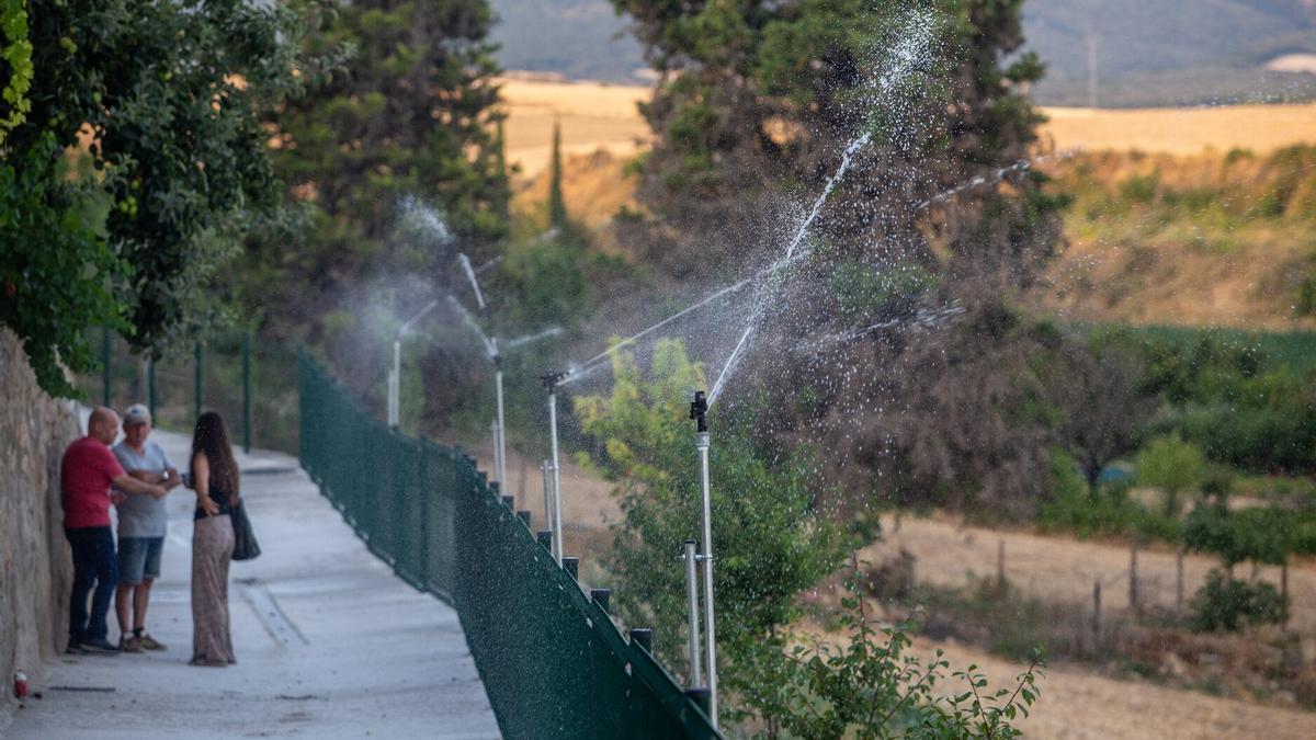 Los aspersores humedecen la línea sur de Legarda, por donde el fuego se acercó en 2022.