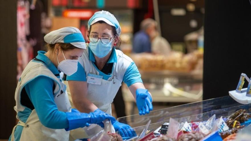Dos mujeres, en su trabajo diario en un supermercado.