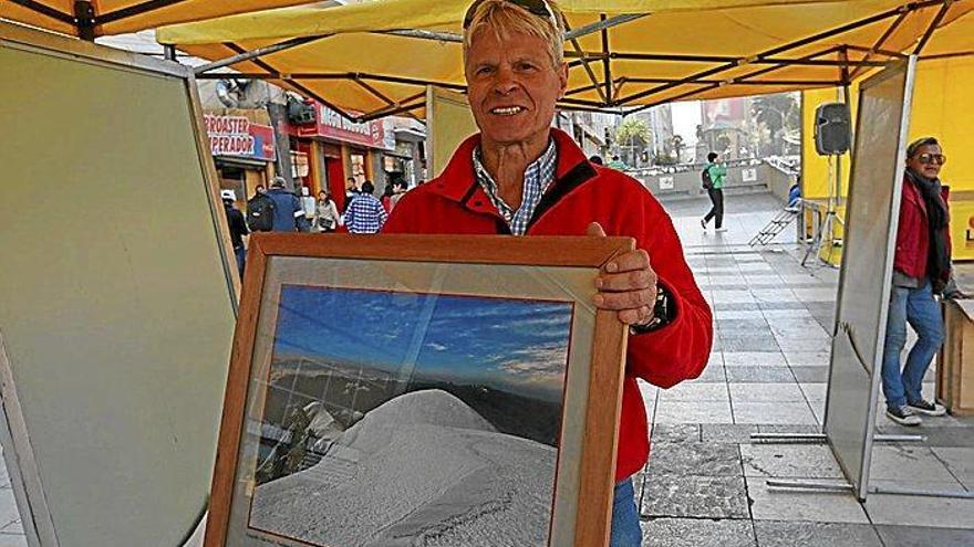 Alain Mesili muestra una de sus fotografías del Illimani expuestas en Bolivia. Foto: Efe
