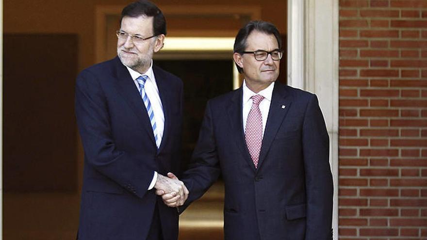El jefe del Gobierno, Mariano Rajoy (i), y el presidente de la Generalitat, Artur Mas, se saludan antes de la reunión.