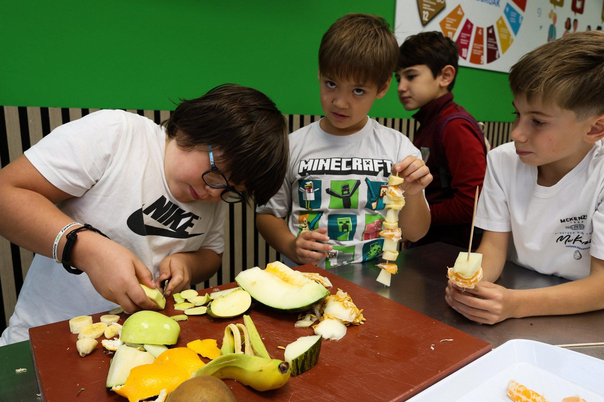 Escolares de San Antonio Ikastetxea de Durango preparan brochetas de frutas en Mercabilbao.