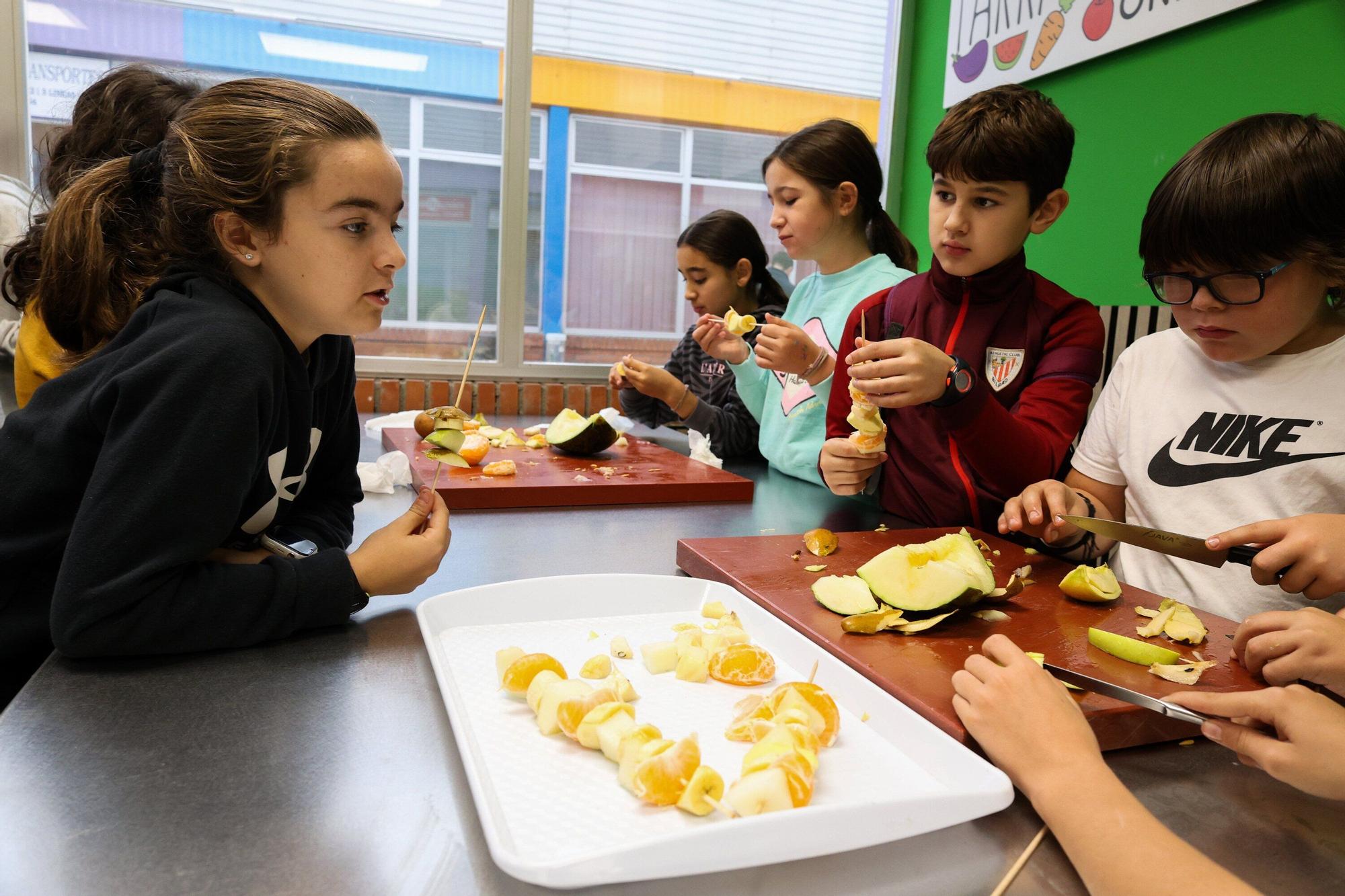 Escolares de San Antonio Ikastetxea de Durango preparan brochetas de frutas en Mercabilbao.