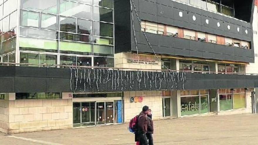Una pareja camina por delante del CIS de Barakaldo.