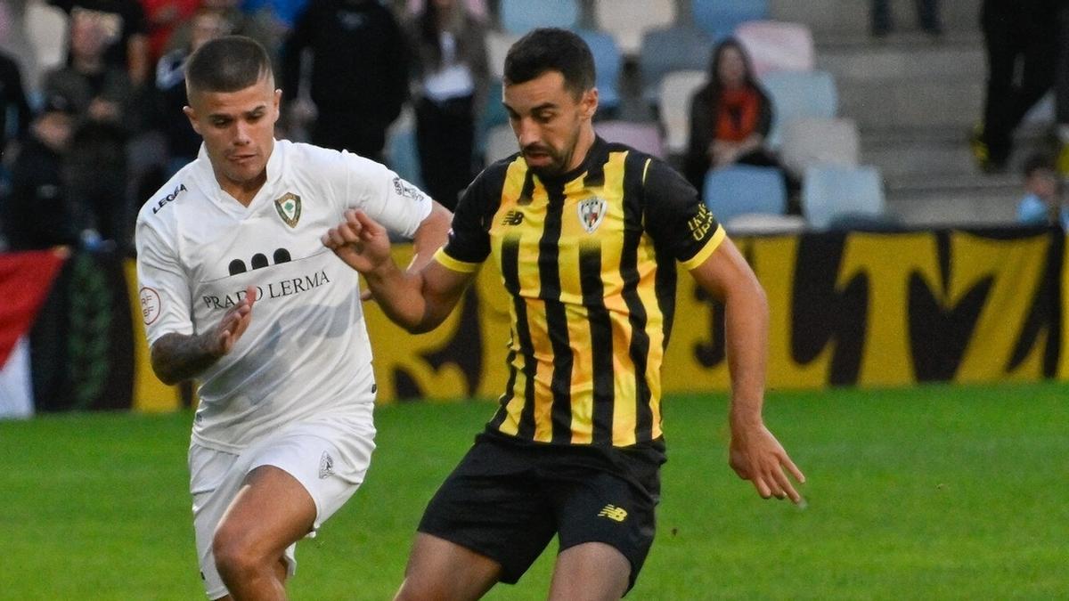 El aurinegro Ekaitz Molina controla el balón ante la oposición de Kepa Vieites.