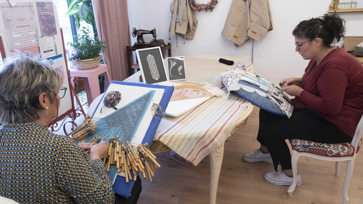 Rebeca Bartolomé y una de sus alumnas en el taller de encaje de bolillos.