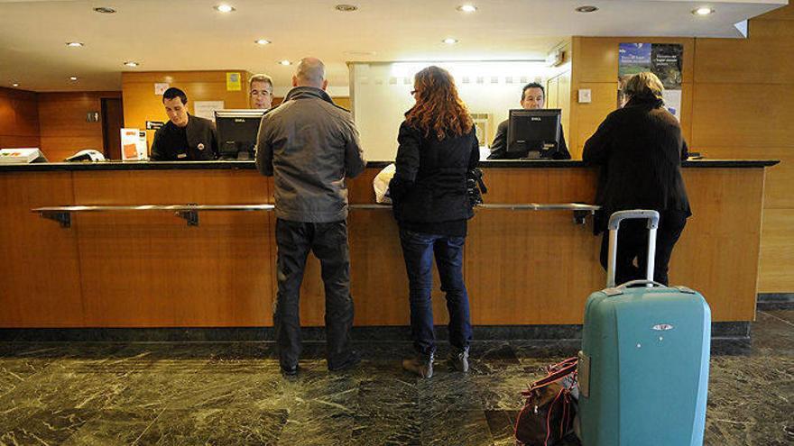 Unos turistas, nada más llegar a la recepción del hotel donde pasarán sus vacaciones.