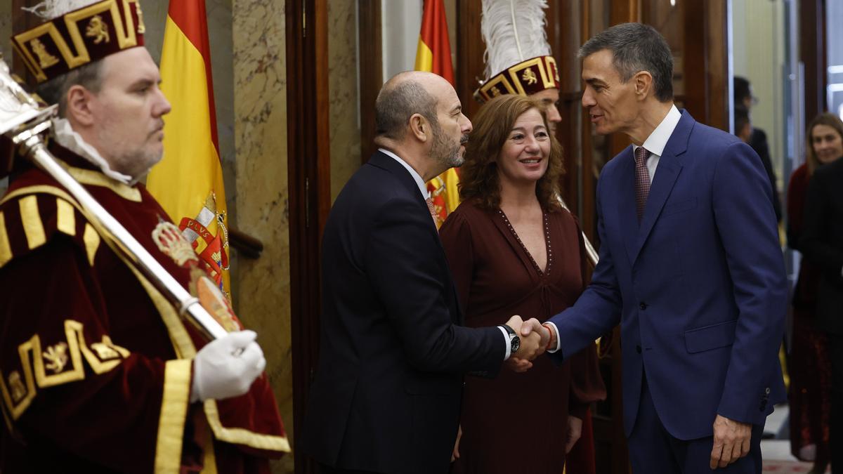 El presidente del Gobierno español, Pedro Sánchez, saluda al presidente del Senado, Pedro Rollán, en presencia de Francina Armengol.