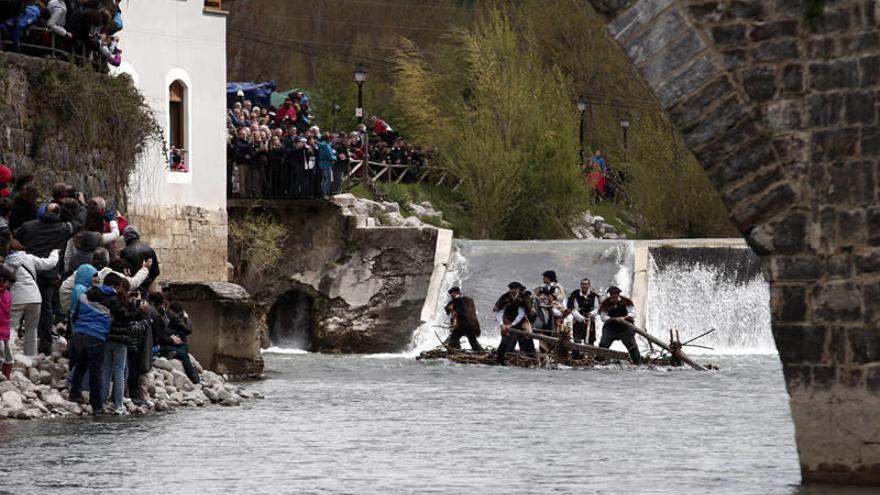 Miles de personas asisten en Burgui al tradicional descenso de las almadías por el río Esca.