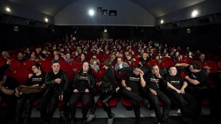 Miembros del grupo &quot;Motxila 21&quot;, formado por jóvenes con Síndrome de Down, esperan sentados en la sala el estreno del documental, &quot;Motxila 21 live!&quot;, que narra la gira londinense del grupo en 2013.