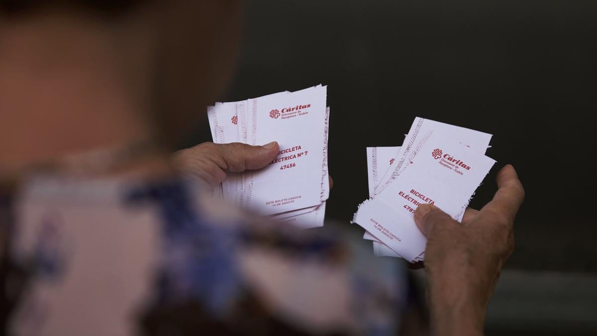 Una persona consulta boletos de la Tómbola.