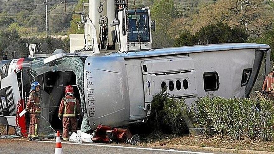 El autocar atravesó la mediana y volcó, colisionando contra un turismo en la AP-7. En la foto, cubierta con sábanas, una de las fallecidas