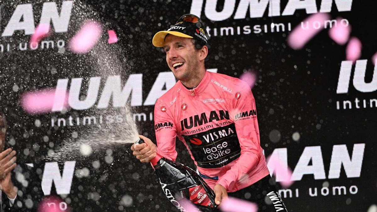 El ciclista británico Simon Philip Yates celebra en el podio con la maglia rosa.