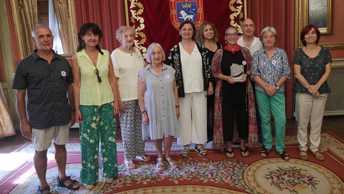 Cristina Serantes, coordinadora de la entidad y encargada de recibir el premio, junto con Carmelo Zabalza, Sara Chivite, Maite Marturet, Mercedes Beonza, Arantxa Muñoz, Lidia Lizarraga, Luisa Jusué, José Javier Pascual y Ana Labiano, nueve de los miembros de la asociación.