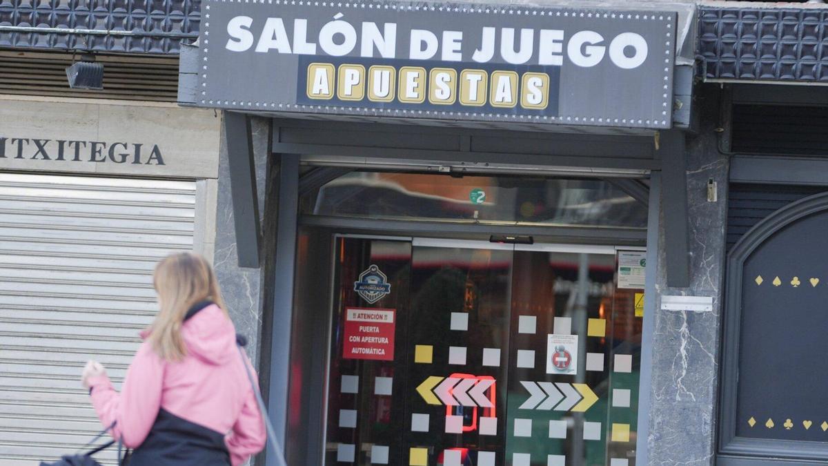 Una mujer camina frente a un salón de juego.