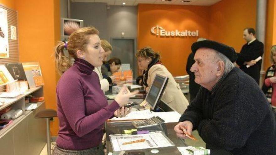 Un cliente atiende las explicaciones de la empleada de una tienda de Euskaltel.