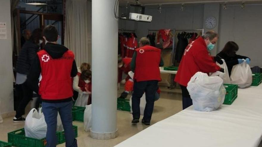 Voluntarios de la Cruz Roja Gipuzkoa preparan bolsas con comida de primera necesidad.