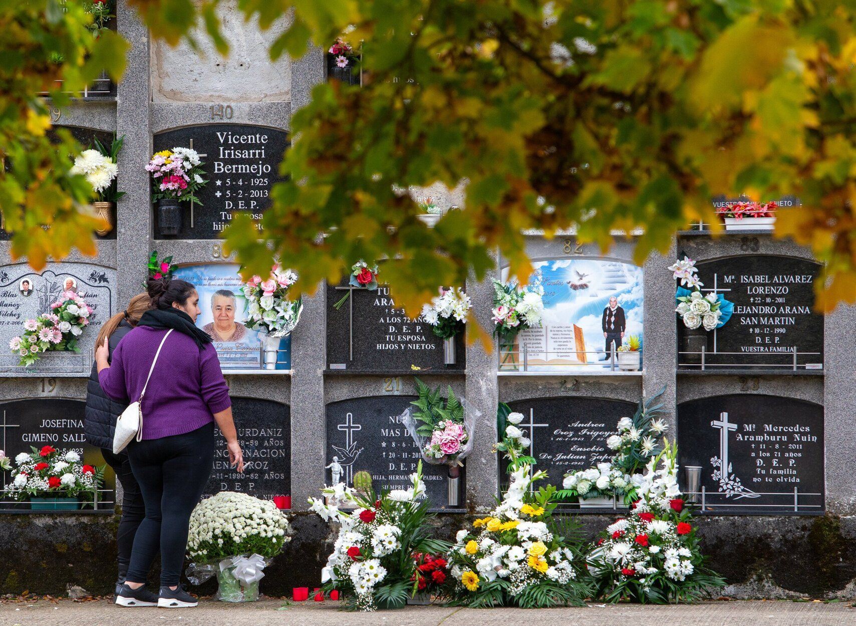 Dos mujeres, ante uno de los nichos del cementerio de Pamplona.